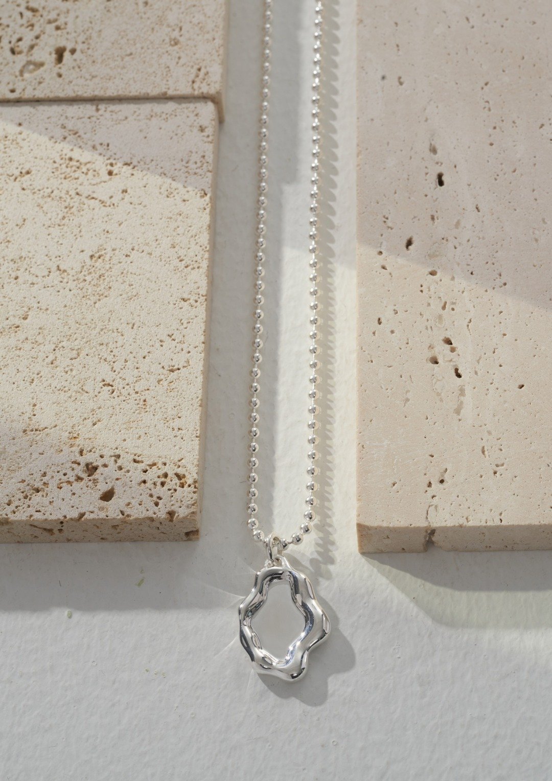 Mirror Lake landscape-inspired sterling silver necklace on model
