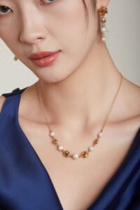 Close-up of asymmetrical textured gold pendant with freshwater pearls