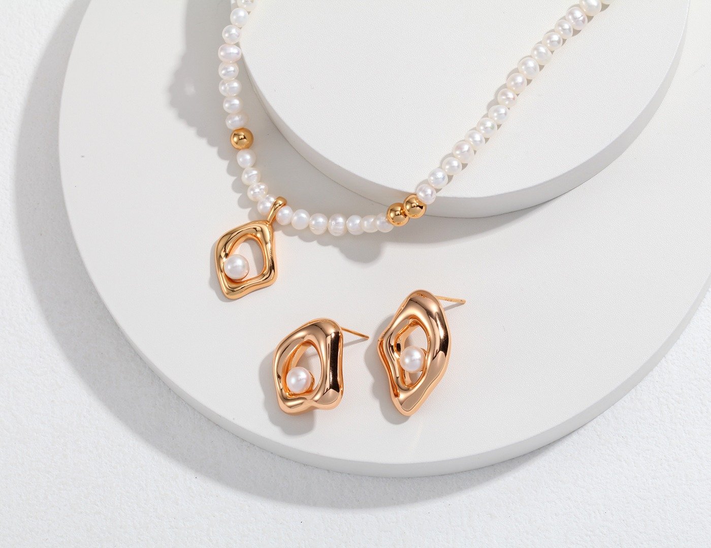 Asymmetric square and diamond pearl earrings on model