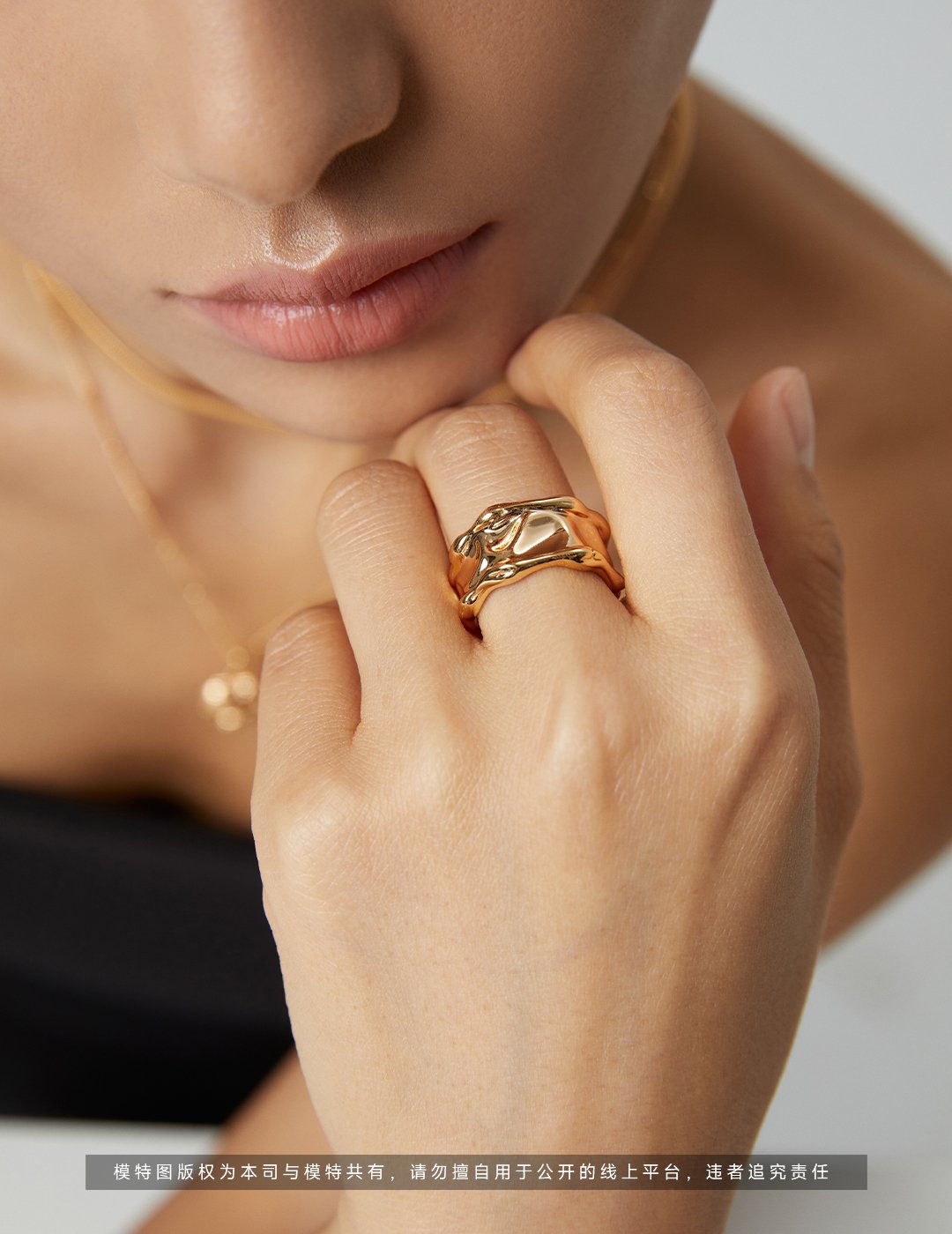 Polished silver lava-textured wide band ring on hand