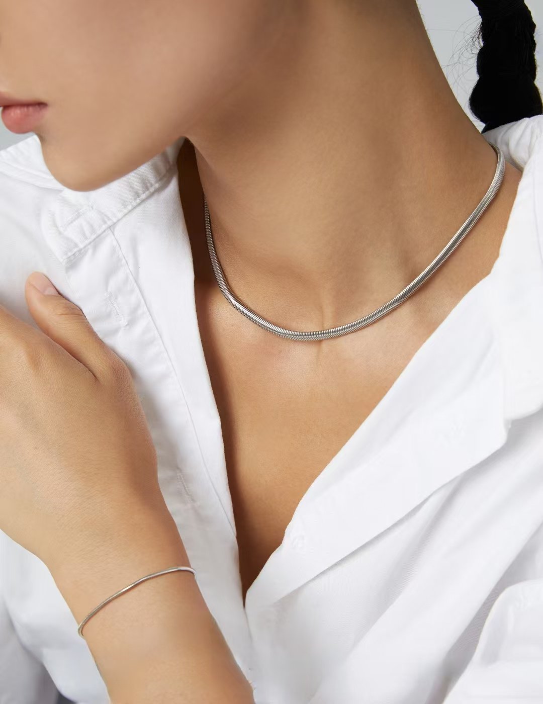 Thick polished silver snake chain necklace on model