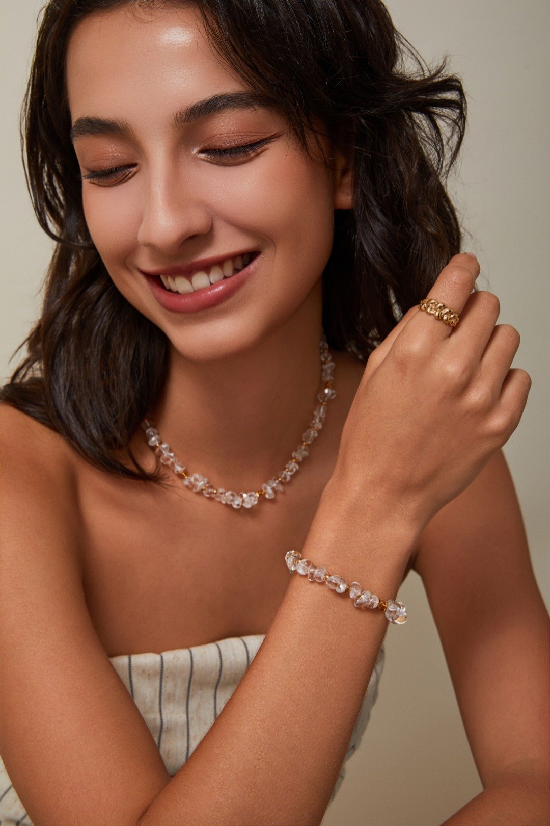 Product Description: Step into timeless elegance with the S925 Silver Vintage Gold Crystal Necklace, a delicate blend of shimmer and structure. Crafted with irregular natural clear crystals, this necklace glows with subtle light reflections, making it a perfect accessory for daily elegance or special occasions. Each stone is interspaced with small golden beads, adding a touch of vintage luxury. Whether worn alone or layered, this piece radiates quiet sophistication. Material & Details: Material: S925 sterling silver with 18K gold plating Stone: Natural clear crystal beads Chain: Gold-plated adjustable extender (approx. 33cm + 6cm) Closure: Lobster clasp Finish: Hand-polished with high-gloss sheen Style: Minimalist, vintage-inspired Styling Tips: Pair with a crisp white blouse or satin slip dress for a refined, luminous look Layer with fine gold chains or gemstone chokers for a luxe stacked style Ideal for date nights, holiday parties, and elegant brunches Packaging: We provide elegant velvet pouches, drawer-style gift boxes, and eco-conscious protective wrapping for every order—perfect for gifts or self-care indulgence. Care Instructions: Keep dry and away from chemicals Store separately in pouch to avoid scratching Gently clean with included polishing cloth