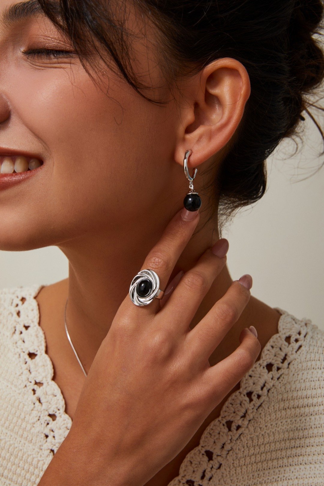 S925 silver and gold sculptural rings with black agate stones displayed on white background